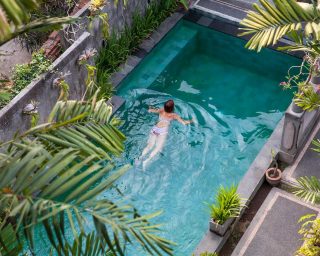 young-woman-swimming-in-the-pool-in-ubud-bali-vi-2022-07-11-03-48-14-utc.jpg